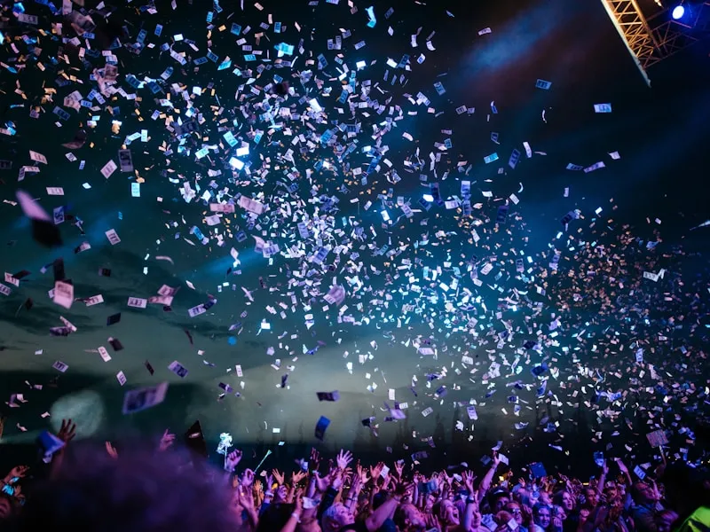 Confetti bursting over a jubilant celebrating crowd