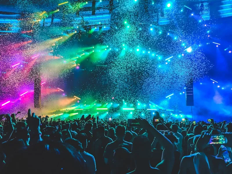 Sea of fans with phones lit at a live night concert